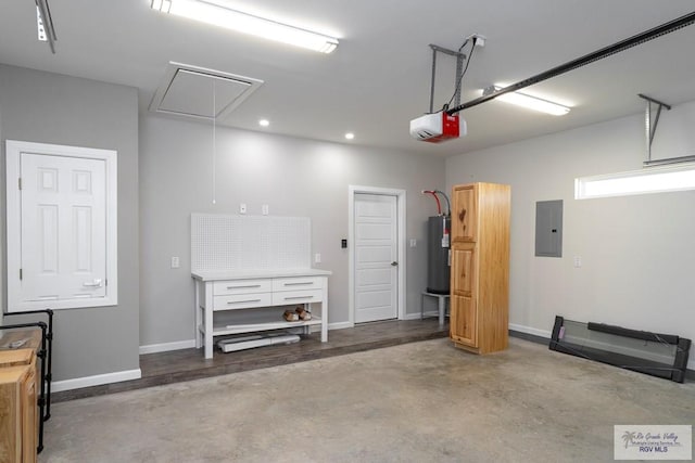 garage with electric panel, a garage door opener, and water heater