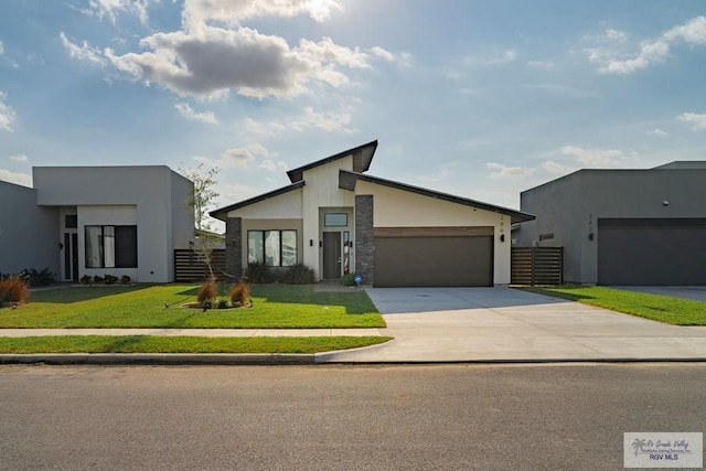 view of front of home featuring a garage and a front lawn