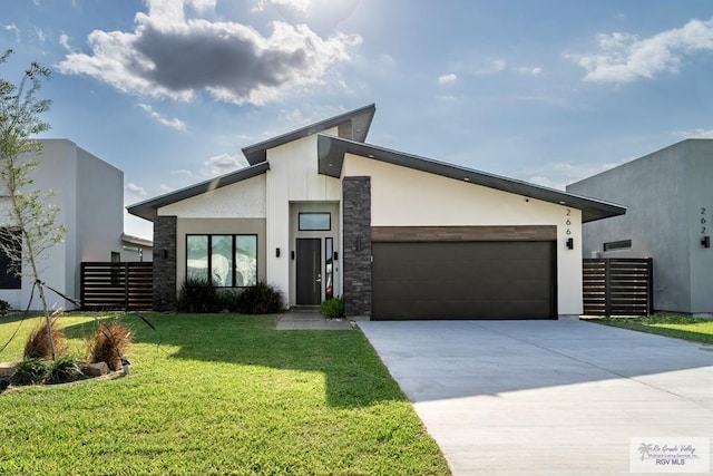 contemporary home with a garage and a front lawn