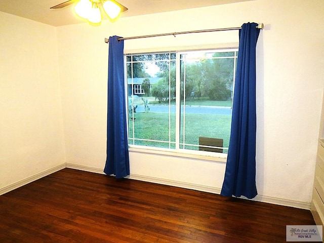 spare room with ceiling fan and dark wood-type flooring