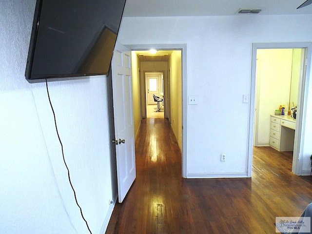 hallway with dark hardwood / wood-style floors