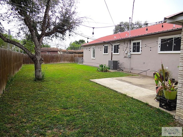 view of yard with a patio and central AC