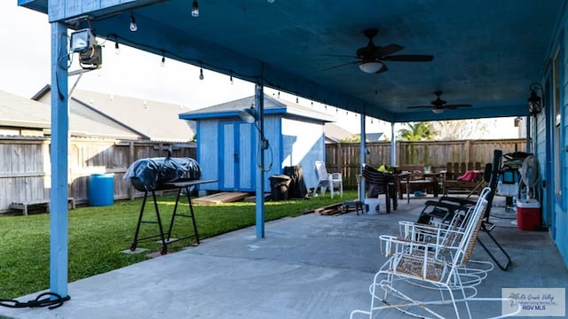 view of patio / terrace with a shed and ceiling fan