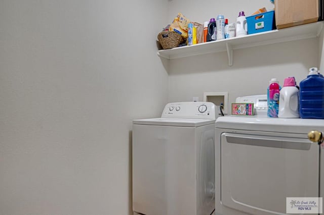 clothes washing area featuring separate washer and dryer