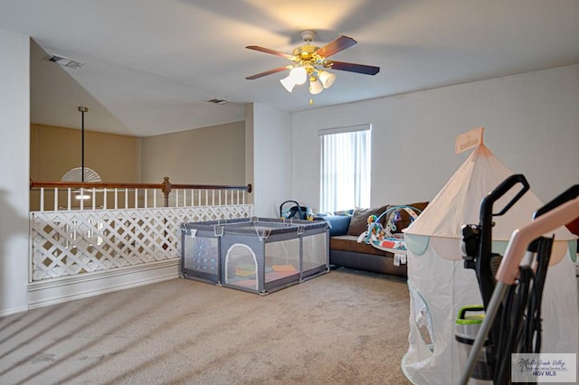 interior space with ceiling fan and carpet flooring