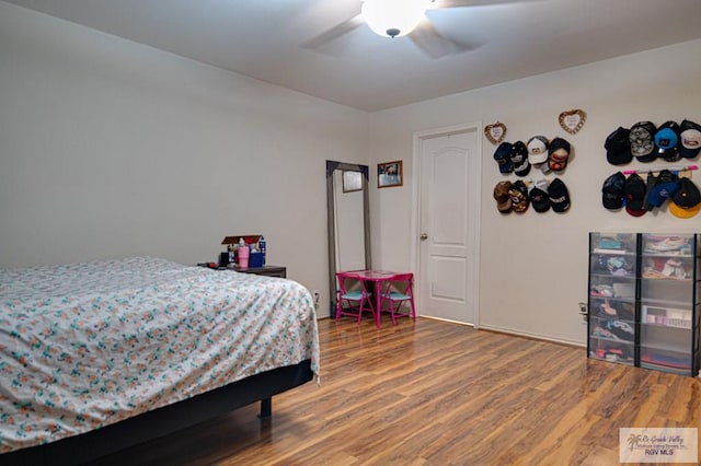 bedroom with wood-type flooring and ceiling fan