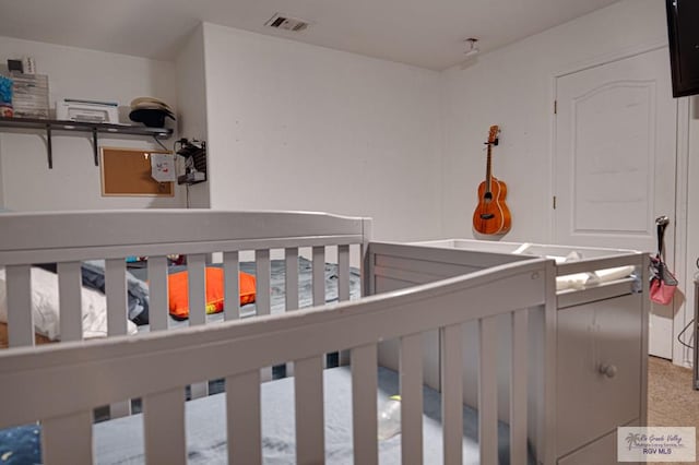 bedroom featuring a crib