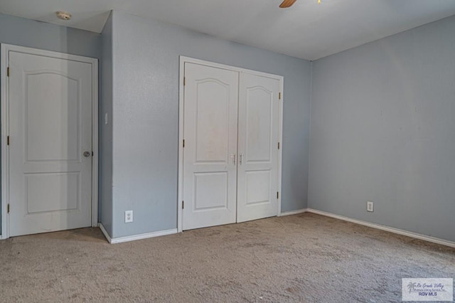 unfurnished bedroom featuring light colored carpet, a closet, and ceiling fan