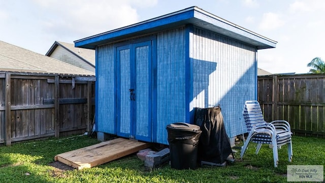 view of outbuilding featuring a lawn