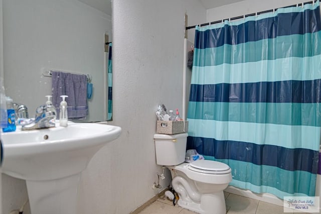 bathroom featuring a shower with curtain, tile patterned floors, and toilet