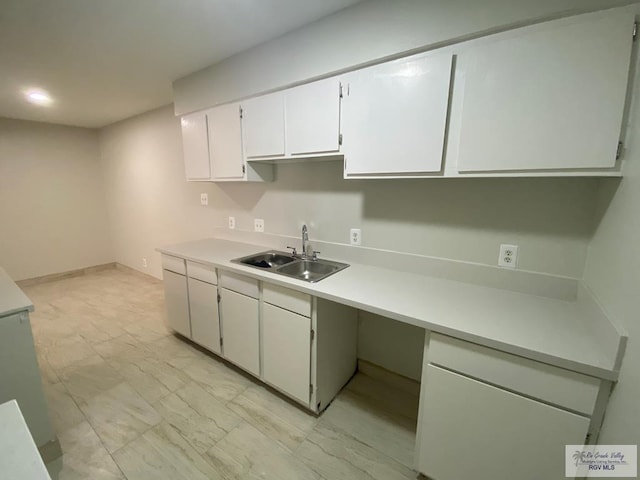 2304 Shidler Dr Unit 10-40, Brownsville, TX 78521 - kitchen featuring light countertops, white cabinets, and light marble finish flooring