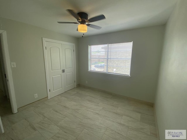 2304 Shidler Dr Unit 10-40, Brownsville, TX 78521 - unfurnished bedroom featuring a closet, light marble finish floors, and a ceiling fan