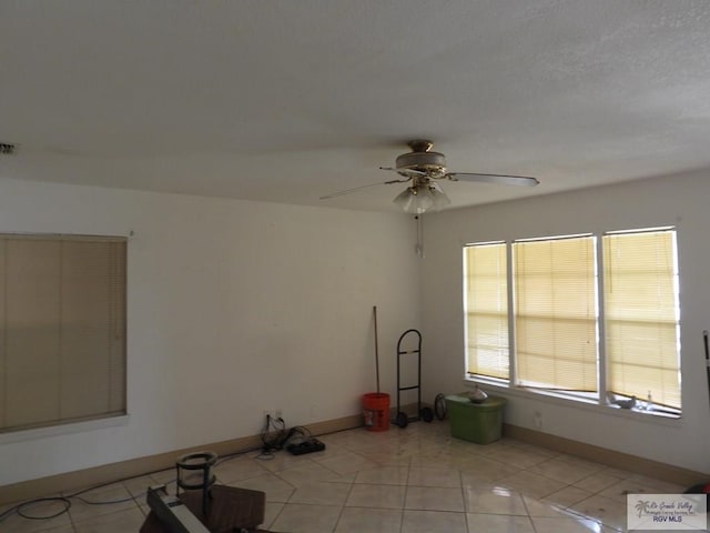 55 Carlton Dr, Brownsville, TX 78521 - spare room featuring ceiling fan, light tile patterned floors, and baseboards