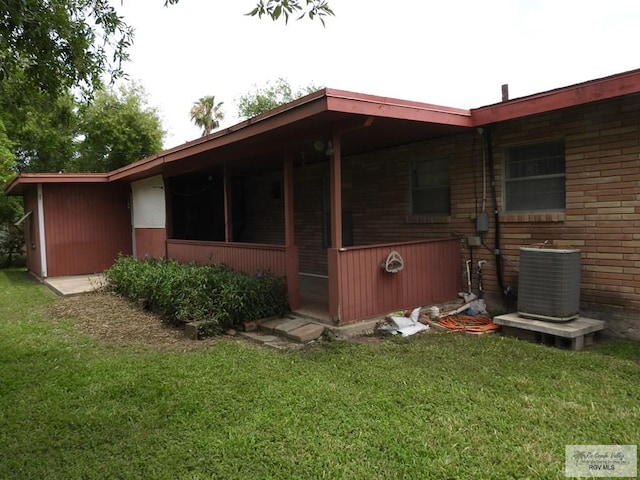 55 Carlton Dr, Brownsville, TX 78521 - view of side of property featuring central AC unit and a lawn