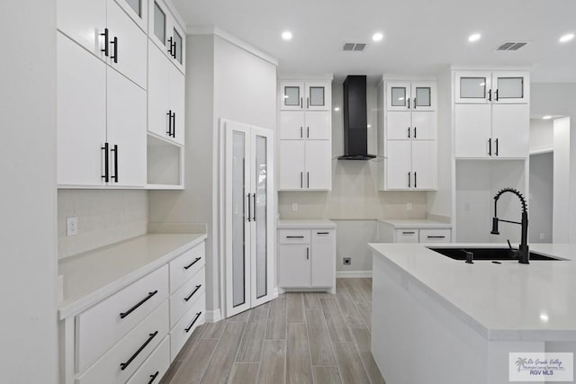 516 Eagle Dr, Los Fresnos, TX 78566 - kitchen featuring wall chimney range hood, a sink, visible vents, and recessed lighting