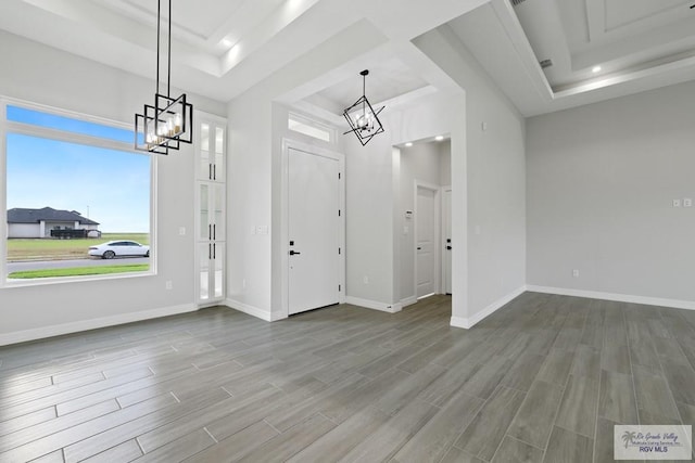 516 Eagle Dr, Los Fresnos, TX 78566 - entrance foyer featuring wood finished floors, baseboards, a chandelier, and a tray ceiling