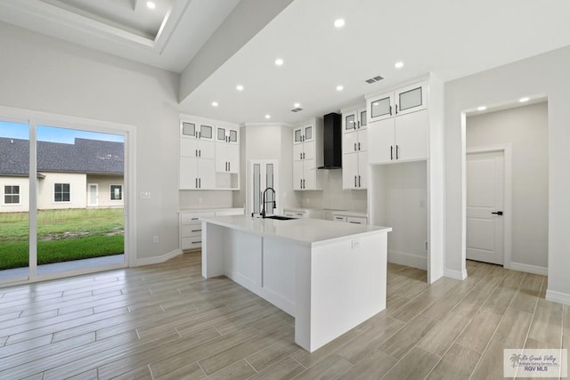 516 Eagle Dr, Los Fresnos, TX 78566 - kitchen with a sink, an island with sink, light wood finished floors, baseboards, and recessed lighting