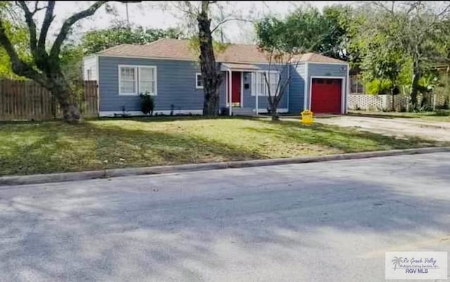 view of front of home with a garage and a front lawn