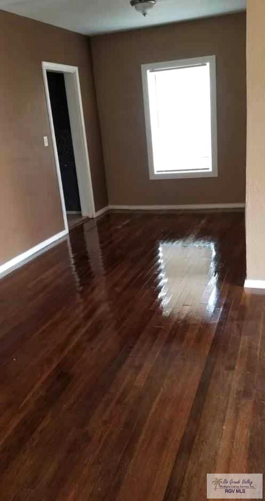 spare room with dark hardwood / wood-style flooring