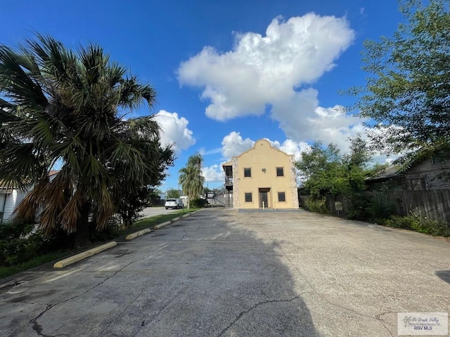 144 N St, Brownsville, TX 78521 - back of property with uncovered parking and stucco siding