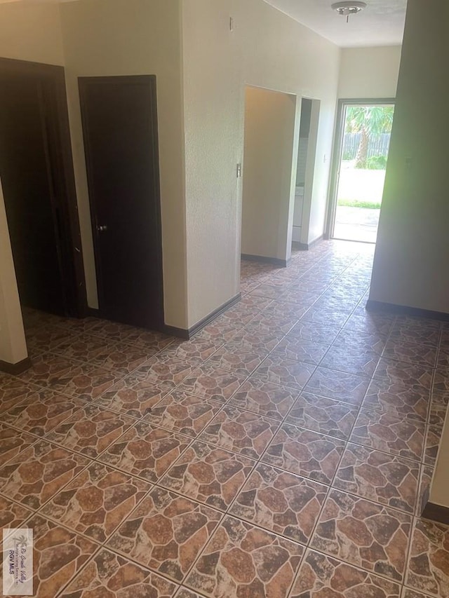 144 N St, Brownsville, TX 78521 - empty room featuring stone finish flooring and baseboards