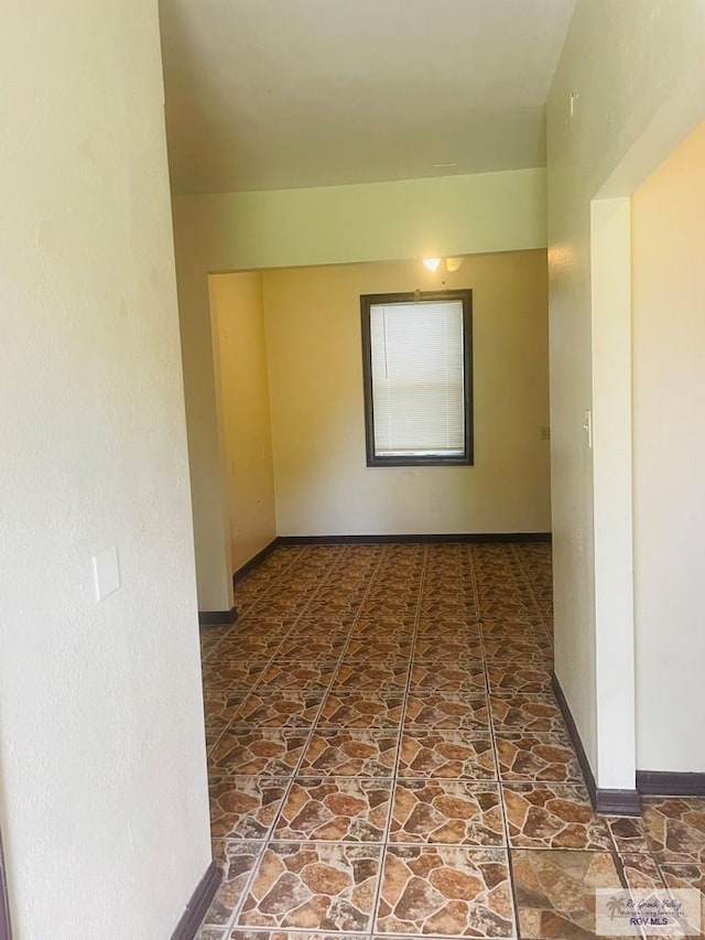 144 N St, Brownsville, TX 78521 - empty room with stone finish floors and baseboards