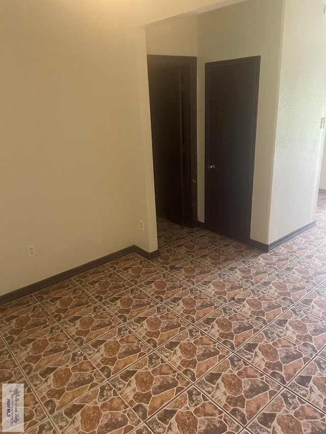 144 N St, Brownsville, TX 78521 - spare room with dark stone finish flooring and baseboards