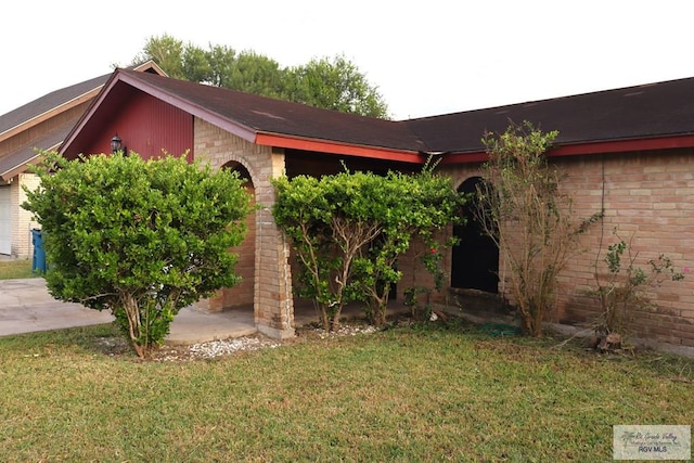 view of home's exterior with a lawn