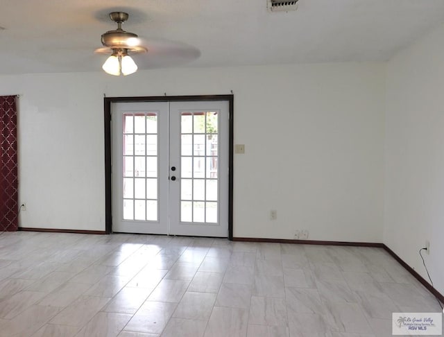 empty room with french doors and ceiling fan