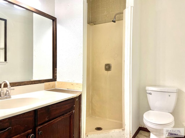 bathroom featuring vanity, toilet, and a shower