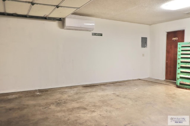 garage featuring a wall unit AC and electric panel