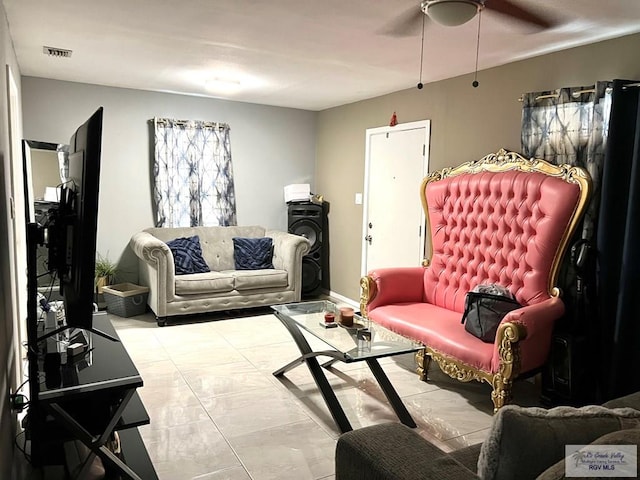 living area featuring baseboards and visible vents