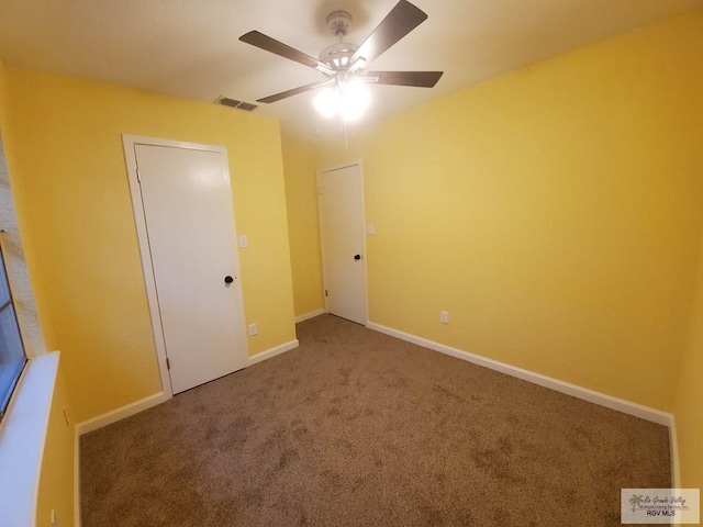 608 W Polk St, Harlingen, TX 78550 - unfurnished bedroom featuring baseboards, a ceiling fan, visible vents, and carpet