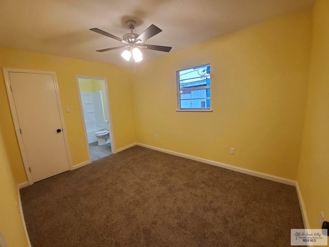 608 W Polk St, Harlingen, TX 78550 - empty room featuring dark colored carpet, baseboards, and a ceiling fan
