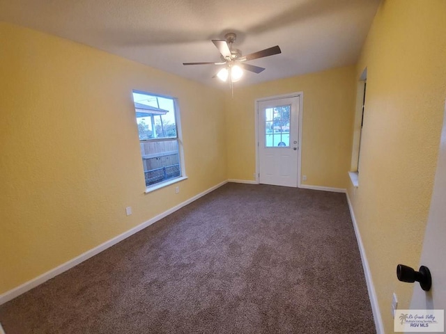 608 W Polk St, Harlingen, TX 78550 - unfurnished room featuring dark carpet, ceiling fan, and baseboards