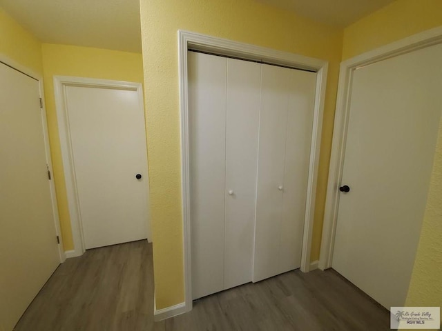 608 W Polk St, Harlingen, TX 78550 - unfurnished bedroom featuring baseboards, wood finished floors, and a closet