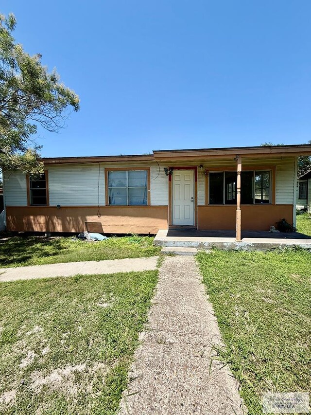 1206 S C St, Harlingen, TX 78550 - view of front of house with a front lawn and covered porch