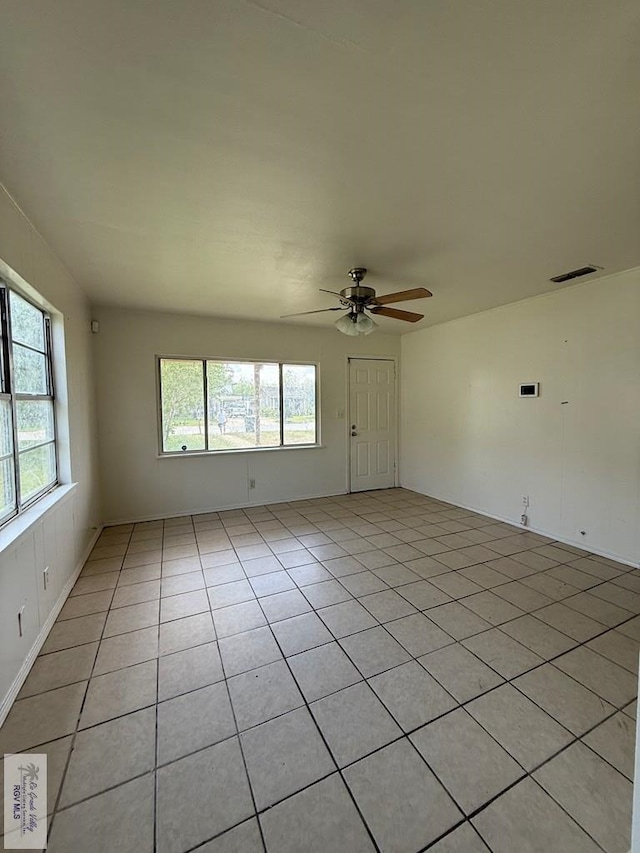 1206 S C St, Harlingen, TX 78550 - unfurnished living room with healthy amount of natural light, a ceiling fan, and light tile patterned floors