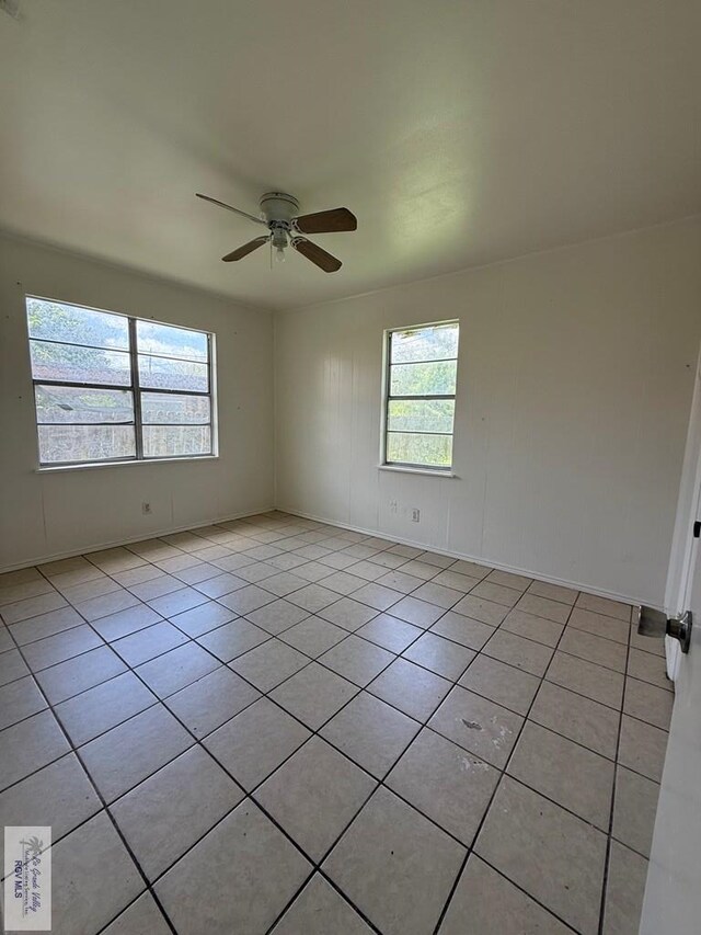 1206 S C St, Harlingen, TX 78550 - spare room featuring light tile patterned floors and a ceiling fan