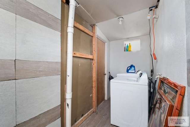 clothes washing area with separate washer and dryer and light hardwood / wood-style floors