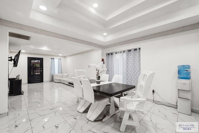 dining area with a raised ceiling