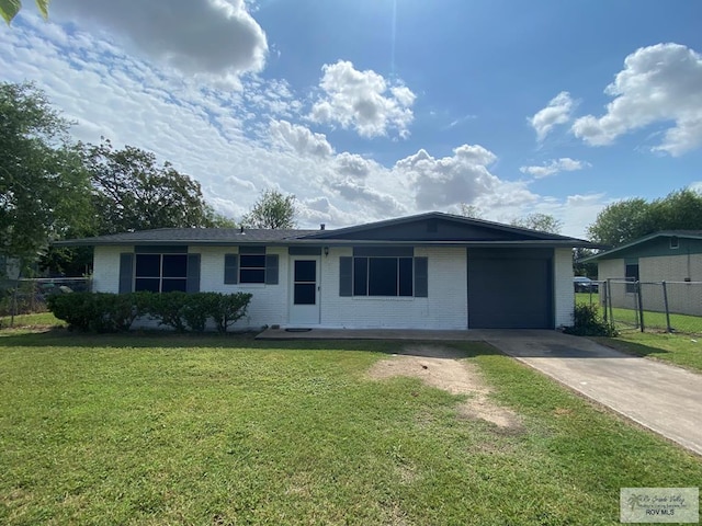 single story home with a front yard and a garage