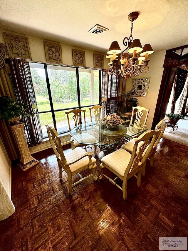 dining area with a textured ceiling and a chandelier