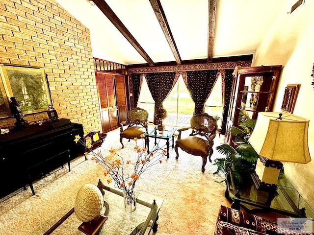 carpeted living room featuring vaulted ceiling with beams and brick wall