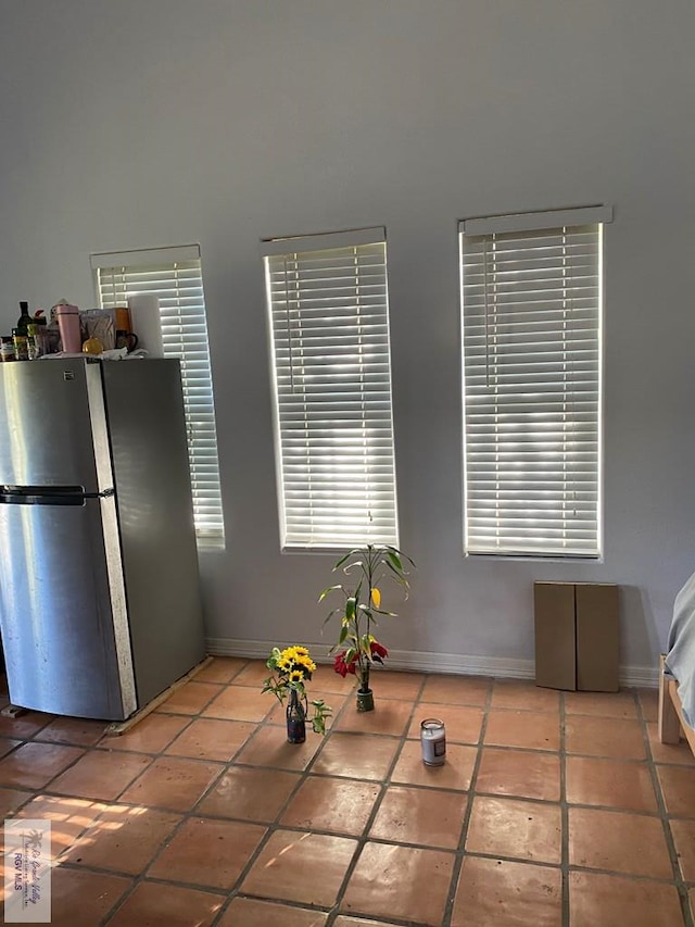 417 SE Verbena Ln Unit 23, La Feria, TX 78559 - kitchen with freestanding refrigerator, tile patterned floors, and baseboards