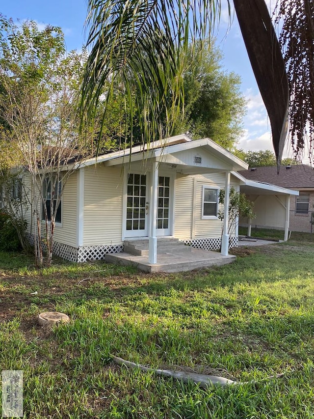 417 SE Verbena Ln Unit 23, La Feria, TX 78559 - view of front of house featuring a front lawn