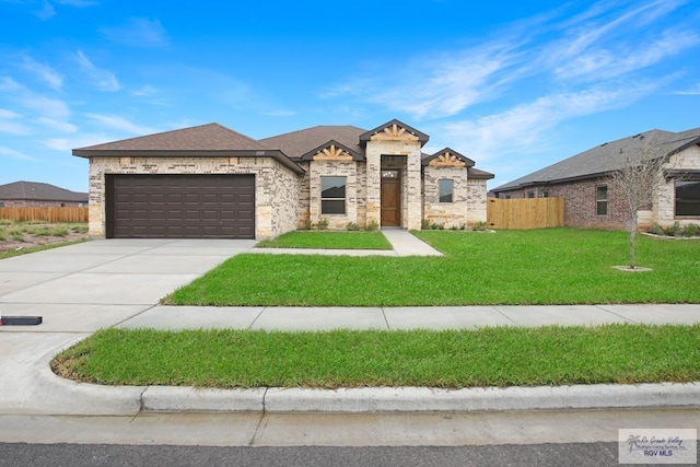 view of front of property featuring a front yard and a garage