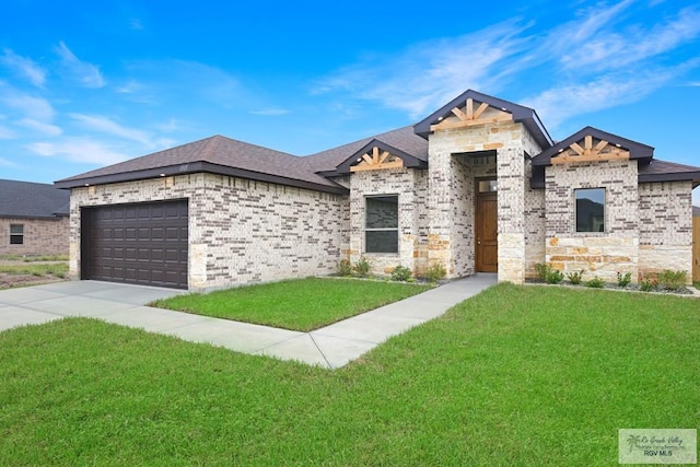 view of front of house featuring a garage and a front lawn