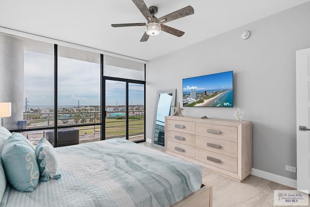 bedroom featuring expansive windows, baseboards, and a ceiling fan