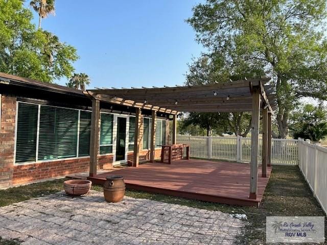 1001 Tesoro Ave, Rancho Viejo, TX 78575 - wooden deck with a pergola and a fenced backyard